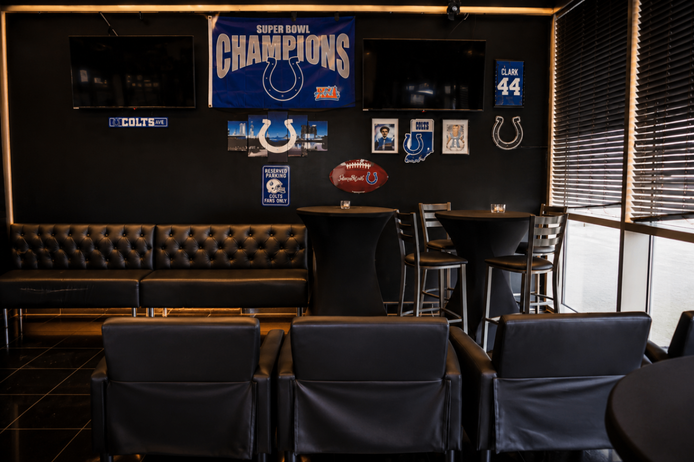 Sports viewing area with Colts decor and screens at Cross Ultra Lounge