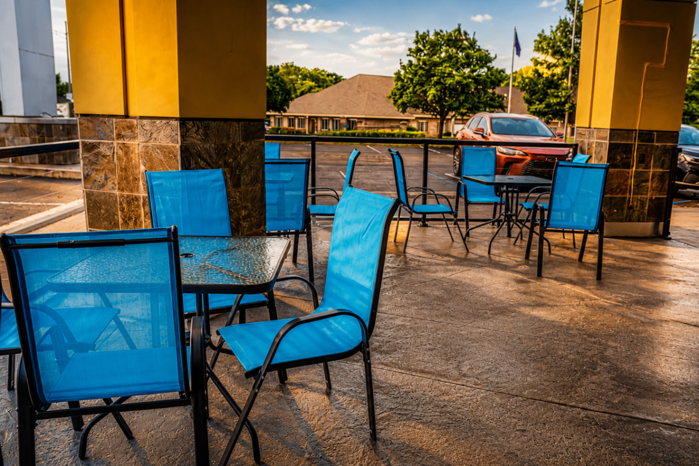 Outdoor patio seating with blue chairs at Cross Ultra Lounge