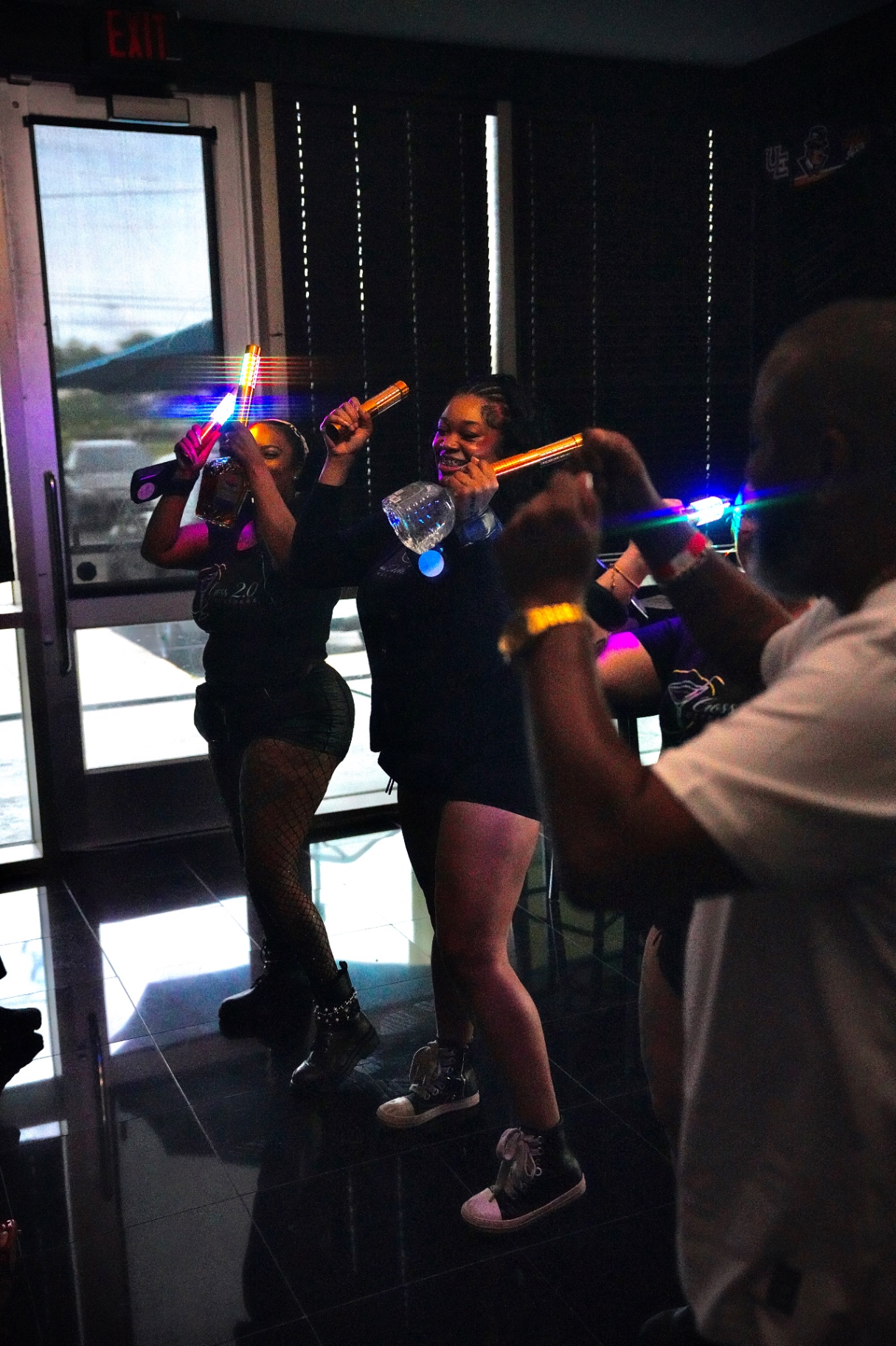 Cross team members bringing bottle service through the lounge